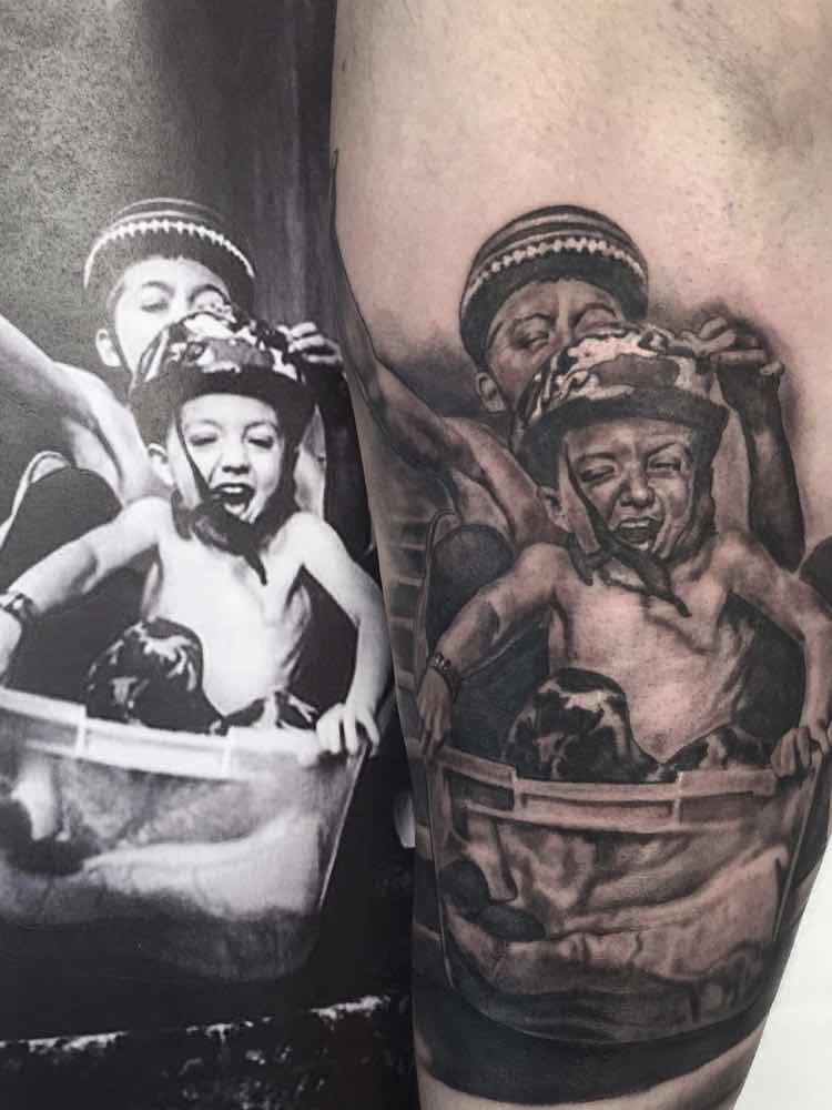 Black and grey Snoop Dogg portrait tattoo on the right